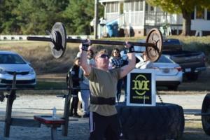 Man lifting weights during a Strongman and Strongwoman competition at Matthew's Gym in Forest City, NC