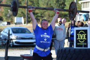 Man lifting weights during a Strongman and Strongwoman competition at Matthew's Gym in Forest City, NC